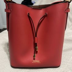 Gorgeous Ralph Lauren Crossbody Bucket Bag In A Red/Pink Colored Leather And Gold Hardware. This Bag Is Very Well Taken Care Of. There Is A Small Stain On The Inner Pocket (Can Be Seen In Photos) But Besides That, Minimal Imperfections. This Bag Gets So Many Compliments. It Is Not Entirely Brand New, But Will Come With The Original Purchase Tag. Measurements 11¾" H X 9¾" L X 5¾" Strap Drop: 19” Red Formal Bucket Bag With Adjustable Strap, Formal Red Bucket Bag With Adjustable Strap, Formal Red Bucket Bag With Gold-tone Hardware, Red Bucket Bag With Dust Bag For Everyday, Red Rectangular Bucket Bag With Gold-tone Hardware, Red Bucket Bag With Handles, Red Crossbody Bucket Bag With Gold-tone Hardware, Red Shoulder Bucket Bag With Dust Bag, Red Bucket Bag With Detachable Strap