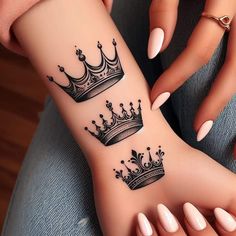 a woman's arm with two tattoos on it and a crown tattooed on the wrist