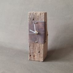 a clock made out of wood on a gray background