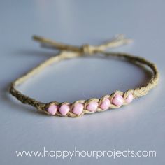 a string bracelet with pink beads on it