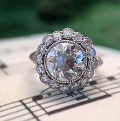 a diamond ring sitting on top of music notes