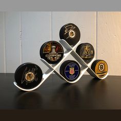 several different types of sports memorabilia are displayed on a table with a white wall in the background