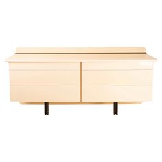 a white dresser sitting on top of a wooden shelf