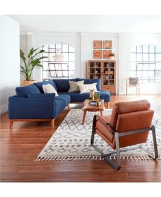 a living room filled with furniture on top of a hard wood floor