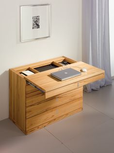 a wooden desk with a laptop on it