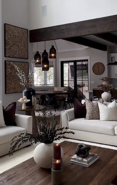 a living room filled with white furniture and lots of wood flooring on top of it