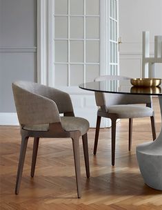 a glass table with chairs around it