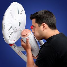 a man holding a white object in front of his face with the words fueling on it