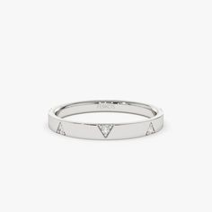 a white gold ring with triangle shaped diamonds