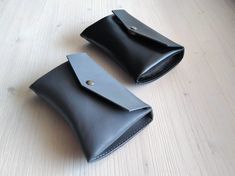 "This tiny leather pouch is the smallest of all our cosmetic bags. It is handmade from thick natural leather. Leather cosmetic bag is perfect for your every day use. It is designed to fit even into a small size handbag/purse and to hold your most important make-up or hygiene essentials (like regular size mascara and lipstick or lip balm and fragrance) in one place. DIMENSIONS + width 6.3\"/16 cm + height 3.9\"/10 cm COLOR + black leather with antique brass color metal parts + grey leather with a Minimalist Leather Clutch Pouch, Minimalist Leather Pouch, Everyday Leather Envelope Pouch, Leather Envelope Coin Purse For Everyday, Black Envelope Pouch For Everyday Use, Leather Pouch Belt Bag Gift, Minimalist Leather Envelope Bag, Minimalist Bags With Removable Pouch As Gift, Handmade Black Pouch For Everyday Use