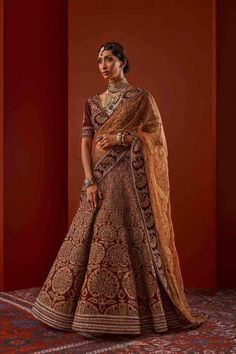 Red Banarasi Silk Lehenga With Sheer Dupatta, Brown Anarkali Set With Dupatta, Brown Lehenga For Wedding And Festivals, Festive Brown Lehenga With Dupatta, Brown Wedding Lehenga For Festivals, Brown Lehenga With Dupatta For Wedding, Bollywood Style Burgundy Dupatta In Traditional Drape, Brown Wedding Lehenga With Traditional Drape, Formal Red Lehenga With Sheer Dupatta