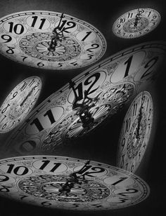 black and white photograph of clocks with numbers on them