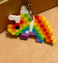 a keychain that is made out of legos and has a rainbow design on it