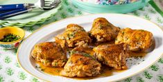 some food is sitting on a white plate and next to a crock pot with green napkins