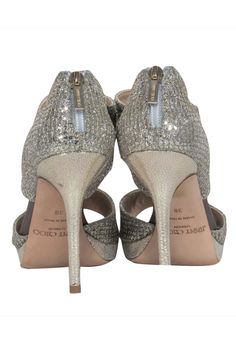 Embrace the epitome of glamour and beauty with these Jimmy Choo champagne gold heels, featuring an open-toe design, pair these heels with a sleek midi dress and a bold clutch for a modern evening look, or add a touch of sparkle to your daytime outfit with a cropped trousers and silk blouse. Size 8 (IT 38) Made in Italy Glitter fabric Leather sole & insole with minimal wear Exposed back zipper closure Gold-toned hardware Platform height 0.7” Heel height 4.7” Gold Heels, Glitter Fabric, Jimmy Choo Shoes, Champagne Gold, Cropped Trousers, Toe Designs, Silver Glitter, Silk Blouse, Jimmy Choo