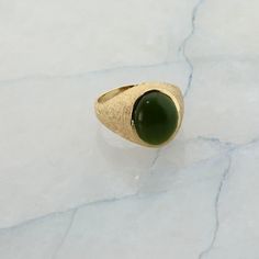 "10K YG Nephrite Jade Ring, Circa 1970, florentine finish to top, polished shank, 5/8\" across, high dome cabochon translucent stone. Size10, 6.6 Grams Stock # R00582A" Green Cabochon Dome Ring For Formal Occasions, Luxury Green Domed Ring, Green Oval Cabochon Signet Ring For Formal Occasions, Formal Green Oval Cabochon Signet Ring, Classic Green Cabochon Signet Ring, Green Domed Jewelry With Polished Finish, Green Oval Cabochon Dome Ring, Green Oval Dome Ring With Polished Finish, Gold Coin Ring