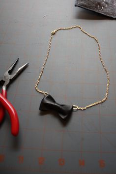 a pair of scissors and a necklace on a table