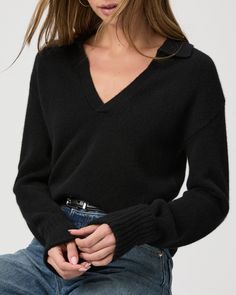 Crafted from Eco Cashmere, this black collared polo sweater features cuffed ribbed sleeves and a classic v-neckline. We'll be wearing this beauty with every shade of denim all season. Part of our Eco-Evolution collection, the Maxie Sweater was made from recycled materials to reduce our environmental impact and minimize waste. The goal of our sustainable efforts is to constantly evolve for the better. We are working hard to source environmentally responsible materials that don’t compromise our ex Cashmere Polo Sweater With V-neck And Ribbed Collar, Black Polo Sweater With Collared Neckline For Workwear, Chic Collared Polo Sweater With Ribbed Cuffs, Classic Black Polo Sweater With Johnny Collar, Winter Polo Sweater With Collared Neckline, Black Collared Polo Sweater With Ribbed Cuffs, Fall V-neck Polo Sweater, Fall Polo Sweater With Ribbed Cuffs And Collared Neckline, Black Polo Sweater For Fall