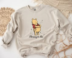 a winnie the pooh sweatshirt sitting on top of a table