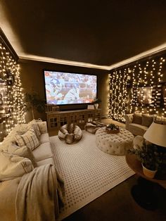 a living room filled with lots of furniture and a flat screen tv mounted to the wall