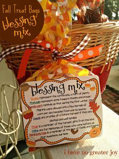 a basket filled with lots of candy sitting on top of a table next to a sign that says blessing mix