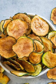 a white bowl filled with cooked zucchini chips