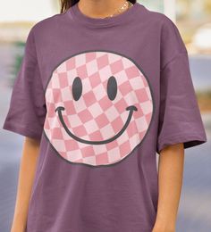 Comfort Colors® Smiley Face Tee Collection: Checkered Smiley Face Crafted from premium 100% ring spun cotton by Comfort Colors, these shirts guarantee comfort and durability. For best results, wash on cold and hang to dry. This Comfort Colors Tee comes in standard unisex sizing. For a more oversized fit, consider sizing up. For those aiming for an oversized "T-shirt Dress" vibe, we recommend going up 2 sizes. Please consult the size chart to ensure the perfect fit for you. If you don't see the color that you want, message us to see if we can make it happen Rest assured, a tracking number will be provided once your order is shipped. Should you encounter any issues or have questions, please don't hesitate to reach out. Your satisfaction is our top priority! Please note: Due to the direct-to- Cheap Smiley Face Short Sleeve T-shirt, Smiley Face Tee, Smiley Face Shirt, Oversized T Shirt Dress, T Shirt Oversize, Smiley Faces, Comfort Colors Tee, Vintage Graphic, Happy Face