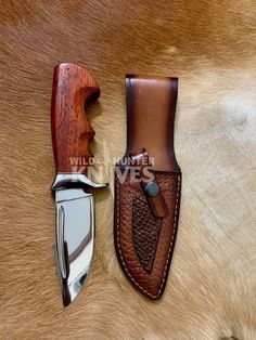 two knives sitting next to each other on top of a brown and white cow skin