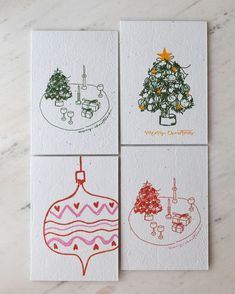 four christmas cards with different designs on them