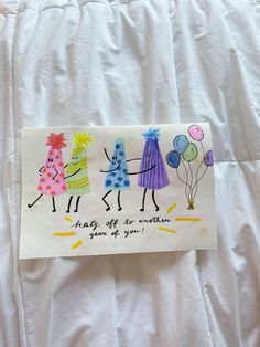 a handmade birthday card with three children holding balloons