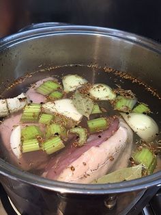 the meat is being cooked in the pot with celery on the stove top