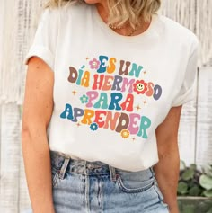 "Teacher Shirt, Maestra Shirt, It's A Beautiful Day For Learning, Bilingual Teacher Shirt, Maestra Bilingual, Bilingual Gift, Maestra Gift ↓ Click here to view our additional fashionable collections ↓ https://handcraftedbyhelenn.etsy.com Product Details: - 100% Cotton (fiber content may vary for different colors) - Medium fabric (5.3 oz/yd2 (180 g/m2)) - Classic fit - Tear away label - Runs true to size Care instructions: - Machine wash: warm (max 40C or 105F); - Non-chlorine: bleach as needed; T Shirt Factory, Education Shirts, Cute Teacher Gifts, Tshirt Printing Design, School Tees, Teacher Outfit, Personalized Clothes, Teacher Outfits, April 20