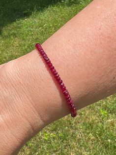 "This handmade women's bracelet is made with the finest quality natural (untreated) red rubies. This is the perfect gift for a July birthday. This bracelet is made just for you, and you can pick the size and finish.  **Please note that the pictures are magnified to show detail. This is a dainty bracelet. *I donate a portion of my sales to a Pug Rescue or charity.* *Ruby is the birthstone for July. *The natural (untreated) Ruby beads are approximately 3-4mm *The clasp and findings are sterling silver, gold-filled, or rose gold filled. *Your purchase will be sent in a gift box. *Please Note: My pictures are magnified to show detail.  -How to determine your bracelet size. STEP 1: Measure your wrist (where you would normally wear your bracelet) using a flexible measuring tape or a strip of pap Ruby Beaded Bracelets With Round Beads For Gift, Ruby Beaded Bracelets As A Gift, Ruby Beaded Bracelets With Round Beads As Gift, Ruby Beaded Bracelets With Gemstone Beads As Gift, Gift Ruby Gemstone Beaded Bracelets, Handmade Adjustable Ruby Bracelet, Handmade Adjustable Ruby Bracelets, Red Rondelle Beaded Bracelets As Gift, Red Rondelle Gemstone Beads Bracelets