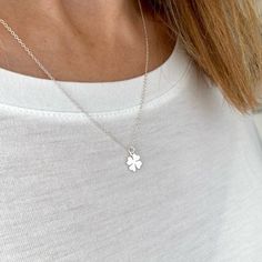 Four Leaf Clover Necklace. A symbol of luck, our pretty sterling silver four leaf clover necklace. Wear everyday as your good luck charm. Choose with or without our personalised disc charm.Tradition says each of the leaves on a four-leaf clover represent something: the first is for faith, the second is for hope, the third is for love, and the fourth is for luck.Necklace is the ideal gift for your family or friends. Surprise them with this good luck necklace, with the four-leaf clover considered Dainty Flower Pendant Charm Necklace For Good Luck, Dainty Good Luck Flower Pendant Charm Necklace, Silver Necklaces With Flower Charm For Good Luck, Silver Necklace With Flower Charm For Good Luck, Clover Leaf Necklace, Personalized Charm Necklace, Luck Necklace, Lucky Charm Necklace, Good Luck Necklace