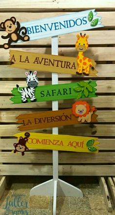 a wooden sign that has different types of signs on it, including animals and letters