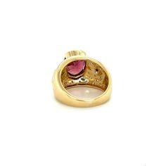 Vintage 6 Carat Pinkish Red Oval Cut Tourmaline Ring. Set in 18K Yellow Gold, this semi-precious gemstone ring weighs 11.5 grams and styles the a retro era look.  The exquisite oval-cut tourmaline, with a charismatic blend of pink and red hues, bears excellent luster and color distribution. Enhanced by the brilliance of 0.40 carats in round cut diamonds in both classic white and dramatic black, elegantly bezel-set, this ring is a harmonious symphony of colors and design.   Item Details: - Type: Luxury Ruby Oval Cabochon Ring, Luxury Ruby Ring Oval Cabochon, Luxury Oval Ruby Ring With Gemstone, Fine Jewelry Ruby Cabochon Ring, Ruby Rings With Center Stone, Oval Cabochon Shape, Elegant Ruby Rings With Oval Cabochon Center Stone, Oval Gemstone Dome Ring In Yellow Gold, Formal Ruby Ring With Oval Cabochon Center Stone, Formal Ruby Ring With Oval Cabochon