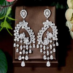 Add A Touch Of Elegance To Your Outfit With These Stunning Cubic Zirconia Long Tassel Drop Earrings. The Earrings Are Beautifully Crafted With A Silver Color And An Asymmetrical Shape. The Dangle/Drop Style Of The Earrings Is Perfect For Any Occasion And Adds A Touch Of Sophistication To Your Look. The Earrings Are Made With High-Quality Cubic Zirconia Stones That Give Off A Brilliant Sparkle. These Earrings Are Perfect For Those Who Want To Make A Statement With Their Jewelry. Water Drop Earrings, Luxury Earrings, Tassel Drop Earrings, Hoop Earring Sets, Halloween Earrings, Asymmetrical Design, Water Drop, Ear Jewelry, High Quality Jewelry