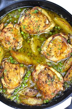 chicken and peas are cooking in a skillet