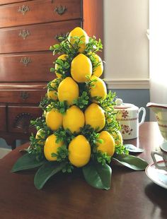 there is a small tree made out of lemons on top of a wooden table