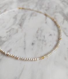 With the essence of the Sun Goddess. This necklace is composed of freshwater pearls and natural 2mm citrine gemstone. So pretty for everyday! It also makes a very cute gift! Available in: ❉ 14K Yellow Gold vermeil ❉ 14K Rose Gold vermeil ❉ 925 Sterling Silver You can choose between 4 chain lengths: 14 / 15 / 16 inches Not sure which length to buy? We can add a 1 inch extender chain. Just write a note at checkout! ❈ We send all our items with registered mail. ❉ Due to the organic nature of stones, there might be a slight variation in colour, size and shape. ✺ All items come packaged in a quality velvet pouch ready for gift giving. ✽ If you want to make a special order, just contact us! White Dainty Pearl Necklace With Gemstone, White Gemstone Pearl Necklace In Dainty Style, Dainty Gold Pearl Necklace With Gemstone, Bracelet Extender, Pearl Necklace Gold, Sun Goddess, Organic Nature, Dainty Choker, Gold Pearl Necklace