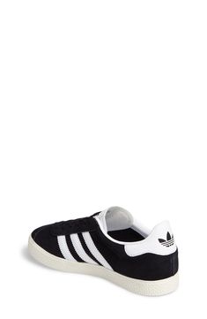 Initially designed as a training shoe for top athletes in 1991, the iconic adidas Gazelle sneaker has been refreshed with a sleek, narrower silhouette but retains the classic 3-Stripes and heel tab of the original. Lace-up style Removable OrthoLite® insole Leather and synthetic upper/textile and synthetic lining/rubber sole Imported Kids' Shoes Adidas Sporty Sneakers For School, Adidas Tennis Sneakers With White Sole, Adidas Low-top Sneakers For School, Sporty Adidas Sneakers For School, Black High-top Tennis Sneakers, Sporty Lace-up Skate Shoes For School, Adidas Casual Sneakers For School, Sporty Low-top Sneakers For School, Sporty Black Basketball Shoes For School