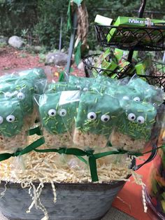 some kind of food with googly eyes on it sitting in a bucket filled with rice