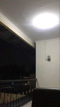 a living room filled with furniture and a flat screen tv mounted on the wall next to a balcony