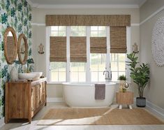 a bathroom with an oval tub and bamboo shades