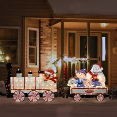 a christmas scene with teddy bears riding in a train and snowmen on the side