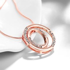 Slip on this elegant double wheel pendant necklace to add a dash of shimmer to your darling ensemble. Chain: 18" with 2.5" extender Pendant: 1.06'' W x 1.06'' H 18k rose gold-plated copper / cubic zirconia Lobster claw clasp Weight: 9.8 g Rose Gold Circular Metal Jewelry, Rose Gold Metal Necklaces For Anniversary, Rose Gold Metal Necklace For Anniversary, Anniversary Rose Gold Metal Necklace, Rose Gold Circle Jewelry For Anniversary, Necklaces Women, Halo Necklace, Buy Necklace, Rose Jewelry