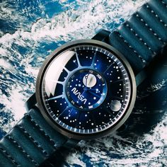 a watch sitting on top of a blue surface