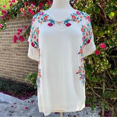 This Top Is So Pretty. The Embroidery Is So Beautiful And Crisp With So Many Colors! Unique And One - Of-A-Kind. V-Neck With Crocheted Lace. Embroidery Goes Down About 20” Down Each Side. Measures Approx 32”Across Chest, 15” From Bottom Of Arms Eye Down Side-Seam To Hem, 9” Sleeve Opening, 8 1/2” Shoulder Seam. Jersey Back. Camisole Underneath Included Measures 20” Across Chest And 20” Down Side Seam. See Photos For Care . Never Worn. Casual V-neck Embroidered Top With Multicolor Embroidery, Summer V-neck Top With Geometric Embroidery, V-neck Blouse With Multicolor Embroidery For Vacation, Multicolor Floral Embroidered V-neck Top, Multicolor Embroidered V-neck Top For Vacation, Spring Vacation Embroidered Top With Embroidered Neckline, Spring Vacation Embroidered Neckline Top, Summer Embroidered V-neck Top, Embroidered V-neck Top For Summer