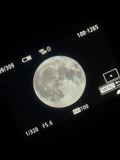 an image of a full moon taken on a cell phone with the time and date