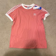 Brand New! Trendy Short Sleeve Adidas Shirt. Perfect For Everyday Wear. Bought From Urban Outfitters. Adidas Three Stripes T-shirt For Spring, Casual T-shirt With Three Stripes Branding For Spring, Spring Peach Crew Neck T-shirt, Adidas T-shirt With Three Stripes For Spring, Spring Short Sleeve T-shirt With Three Stripes, Heather Peach Letter Print Top For Spring, Adidas Three Stripes Summer Tops, Adidas Summer Tops With Three Stripes, Trendy Adidas T-shirt For Spring